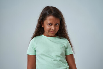 Obraz premium Dissatisfied hispanic little girl look at camera