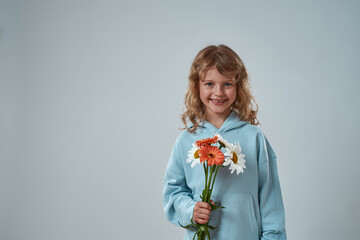 Little girl holding bouquet of flowers for present