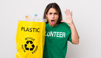 pretty hispanic woman screaming with hands up in the air. ecology concept