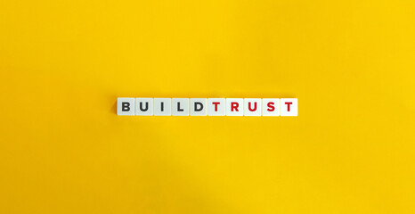 Build Trust Phrase on Letter Tiles on Yellow Background. Minimal Aesthetics.