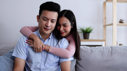 Young Asian woman reconciles her boyfriend and hugging from back, Couple concept