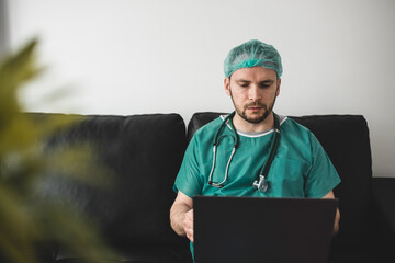 Doctor looking at laptop in the resting room