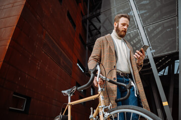Young man using smartphone with mobile app. Creative businessman in a modern business area.