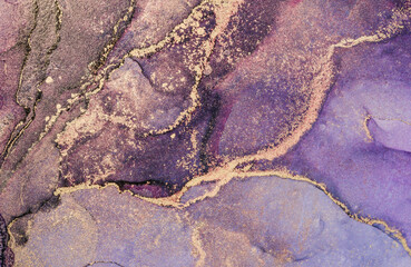 Alcohol ink colors modern fluid art background. Abstract blue, purple and gold texture background. Design wrapping paper, wallpaper. Mixing acrylic paints.