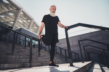 Full size photo of aged white hair fit man do stretch wear black t-shirt shorts sneakers outside in town