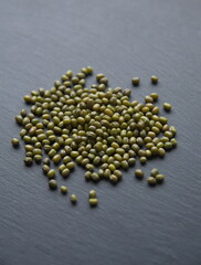Green Lenteja, classic spanish variety of  lentil (Lens culinaris or Lens esculenta),  edible legume, lens-shaped seeds on grey stone background