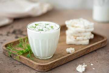 homemade natural kefir with rice cakes in a glass - obrazy, fototapety, plakaty