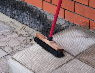 A Broom standing on house doorstep