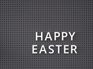 Words Happy Easter spelled out with white letters on gray pegboard