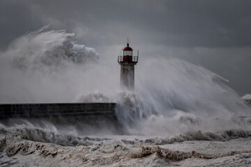 Fototapeta na wymiar Stormy waves over old lighthouse