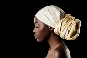 The profile of beauty. Studio shot of a beautiful woman wearing a headscarf against a black background. - obrazy, fototapety, plakaty