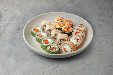 sushi set with maki rolls on gray background