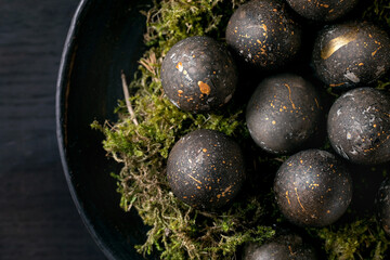Bio colored black eggs with golden spots