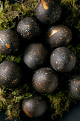 Bio colored black eggs with golden spots