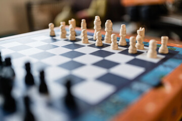 Chess piece set on the chessboard. Focus on the white side. Game on for challenge and strategic competition.