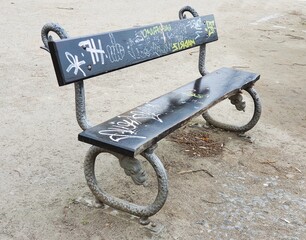 Fototapeta na wymiar Park bench with graffiti