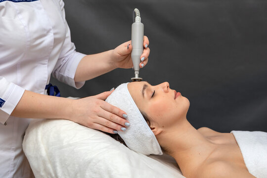 A girl's face in close-up during a facial treatment at a cosmetologist.The cosmetologist does biomechanical stimulation of the face to the client.The concept of professional cosmetology.