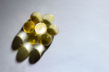 solated capsules in the form of balls on a background of shadows and light like a round polyhedron in different colors