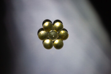 solated capsules in the form of balls on a background of shadows and light like a round polyhedron in different colors