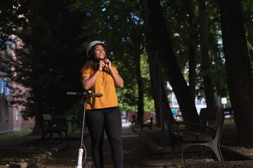 Smiling black woman fastening helmet before scooter ride