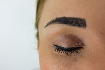 Closeup portrait of beautiful woman, closed eye, black makeup