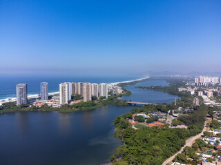 Obraz na płótnie Canvas Amazing seaside town in the middle of the mountains with a river flowing - drone aerial view - Barra da Tijuca, Rio de Janeiro, RJ, Brazilian Beach
