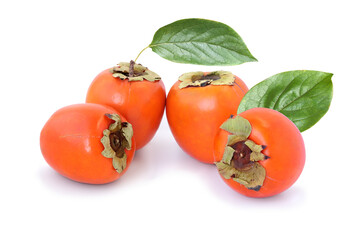 Four persimmons with leaves isolated on white background