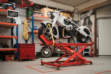 Papier Peint photo autocollant Moto Fixation d& 39 une moto personnalisée debout dans un atelier de réparation. Instrumentation et équipement. Passe-temps et emplois uniques