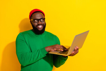 Portrait of attractive cheerful creative guy using laptop typing plan copy space isolated over...