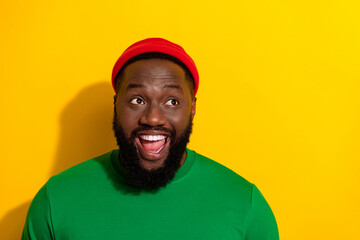 Fototapeta premium Photo of crazy excited man look empty space dream ideas wear red beanie green shirt isolated yellow color background