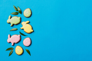 holiday preparation Multi colors Easter eggs with cookies on colored background . Pastel color...