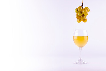 Wine in glasses with grapes on white background.