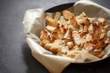 Crackers, dried baked pieces of white bread, selective focus.
