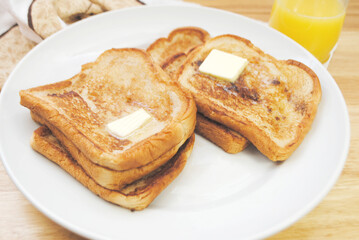 Fried French Toast served on a Plate with Butter	