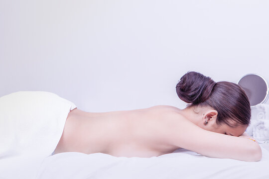 young woman lying on a stretcher waiting for a body massage. High quality photo