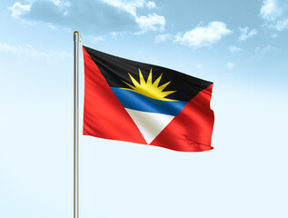 Antigua and Barbuda national flag waving in blue sky with clouds. Antigua and Barbuda flag. 3D illustration