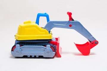 Fototapeta premium Yellow excavator plastic car on white background. Construction machinery car for digging for toy store and children.