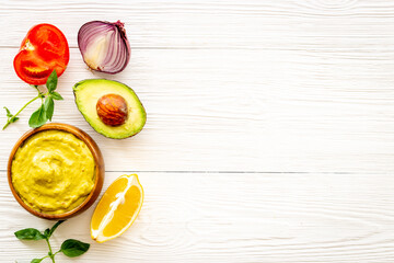 Spicy guacamole avocado dip with herbs and tomatoes