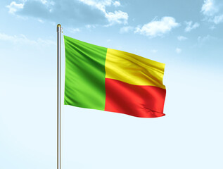 Fototapeta na wymiar Benin national flag waving in blue sky with clouds. Benin flag. 3D illustration