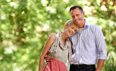 He means the world to me. Shot of a loving mature couple enjoying a day at the park.