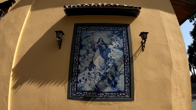 Seville, Spain, September 12, 2021: SLOW MOTION - Virgin Mary small shrine in the streets of Triana. Triana is one of the most essential, charismatic, and colorful neighborhoods of Andalusian city.