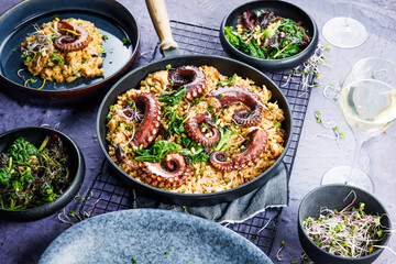 A portion of risotto with octopus tentacles. purple background. Top view