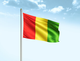 Guinea national flag waving in blue sky with clouds. Guinea flag. 3D illustration