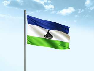 Lesotho national flag waving in blue sky with clouds. Lesotho flag. 3D illustration