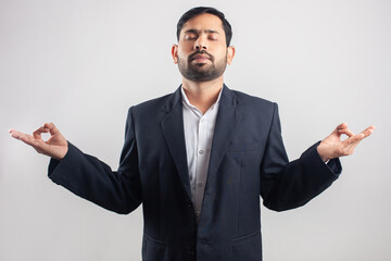 businessman standing with calm yoga posture for relaxation and mind concentration