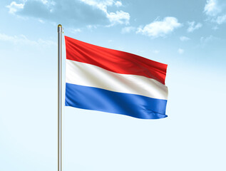 Fototapeta na wymiar Netherlands national flag waving in blue sky with clouds. Netherlands flag. 3D illustration