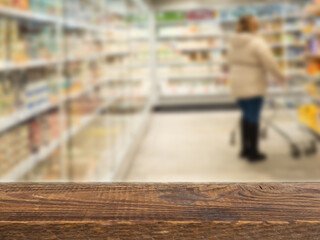 Blackboards with blurred supermarket shelf background, empty wooden table top