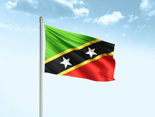 Saint Kitts and Nevis national flag waving in blue sky with clouds. Saint Kitts and Nevis flag. 3D illustration