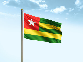 Togo national flag waving in blue sky with clouds. Togo flag. 3D illustration
