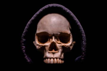 Skull on a black background in a hood